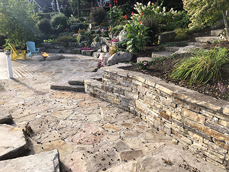 Flagstone Patio with Boulder Gardens and Gas Firepit