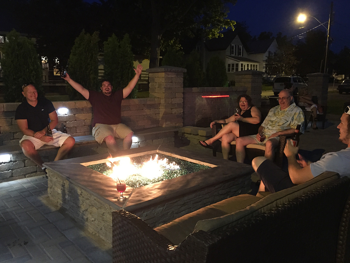 Diners Enjoying Drinks Around the Fire Feature