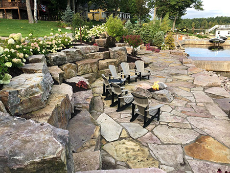 Flagstone Patio with Gas Firepit and Boulder Walls